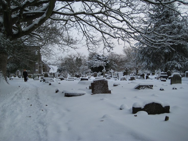 Banstead All Saints graveyard after snowfall