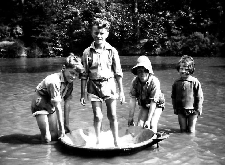 Children playing about in the Cow Pond, Ashfold