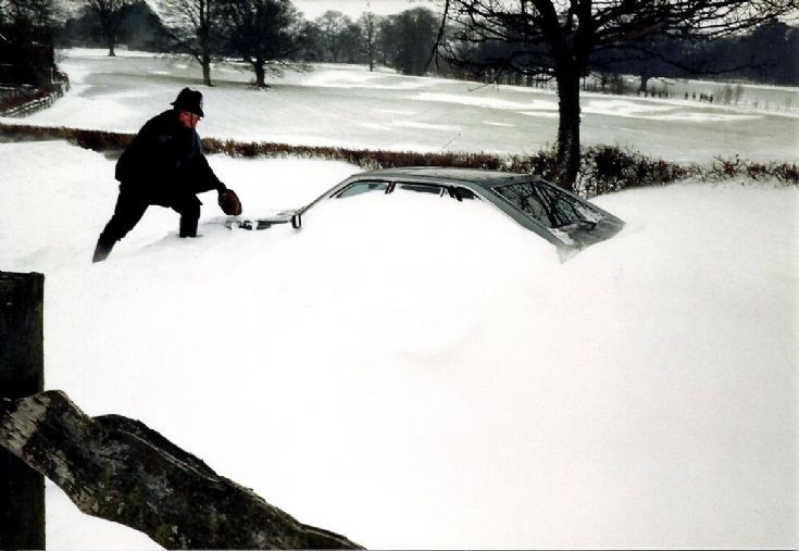 Abandoned car in snow drift