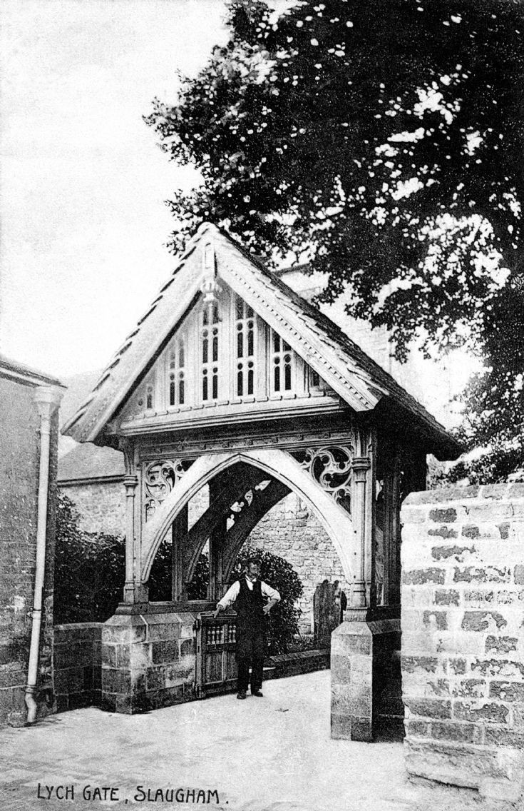 The verger beneath the lych gate at Slaugham