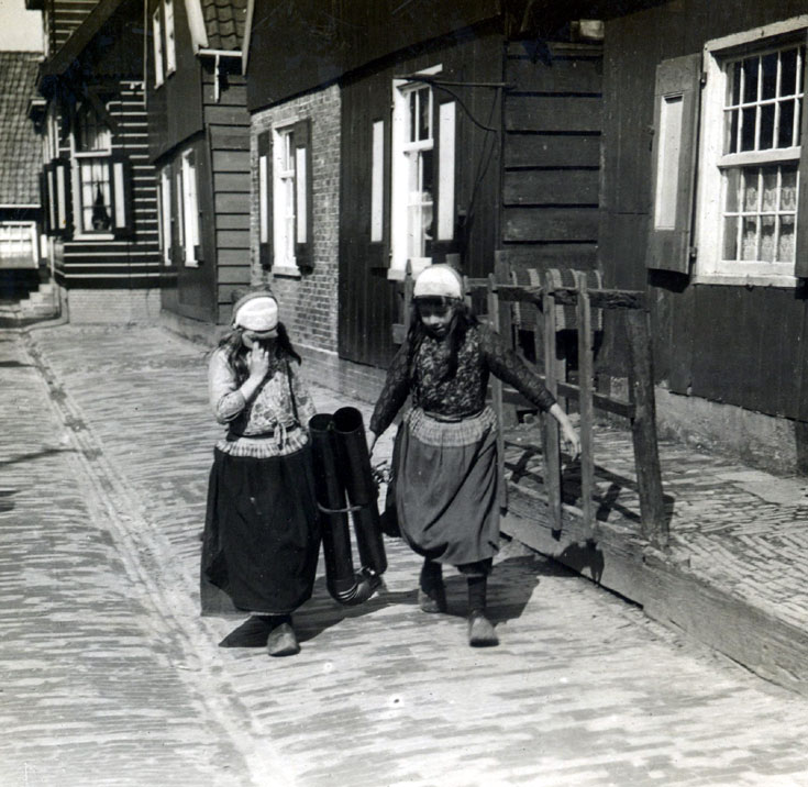 Two shy girls in traditional Dutch dress